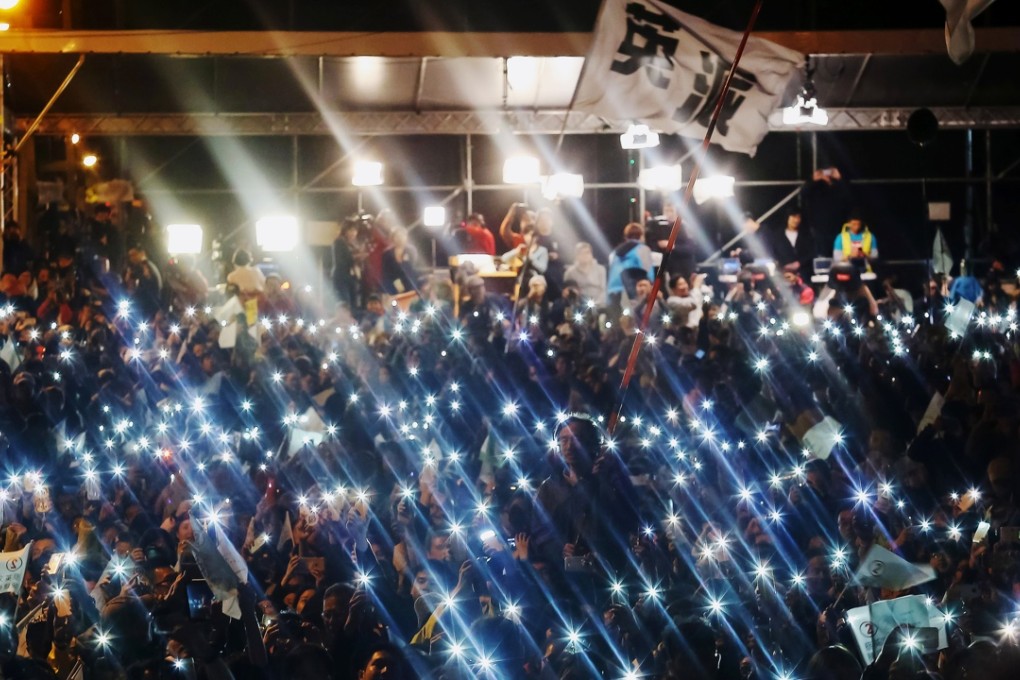 Supporters of Tsai Ing-wen shine lights from their mobile phones as they celebrate the election results during a rally in Taipei. Photo: Bloomberg