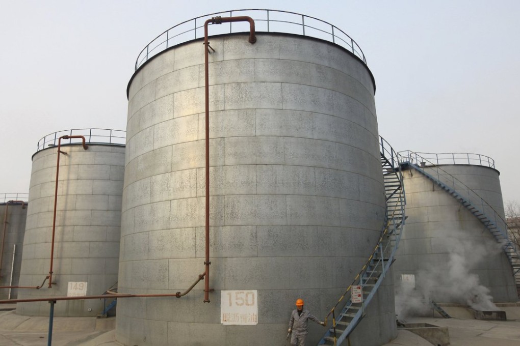 An employee walks down the stairs of an oil storage tank after a regular check at a PetroChina refinery in Lanzhou, Gansu province. Photo: Reuters