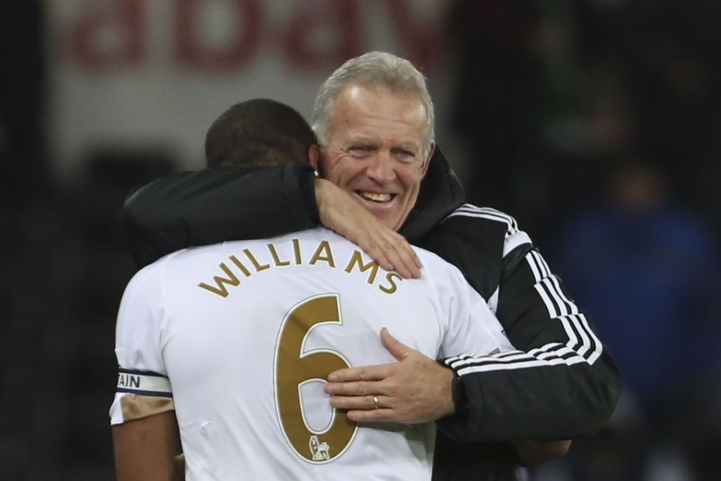 Swansea City defender Ashley Williams celebrates with Alan Curtis after scoring the goal that drags his team clear of the relegation zone. Photo: AFP