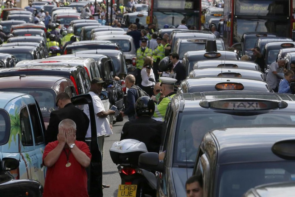 Taxi drivers block the road during a protest against Uber in central London in this 2014 file picture. Photo: Reuters