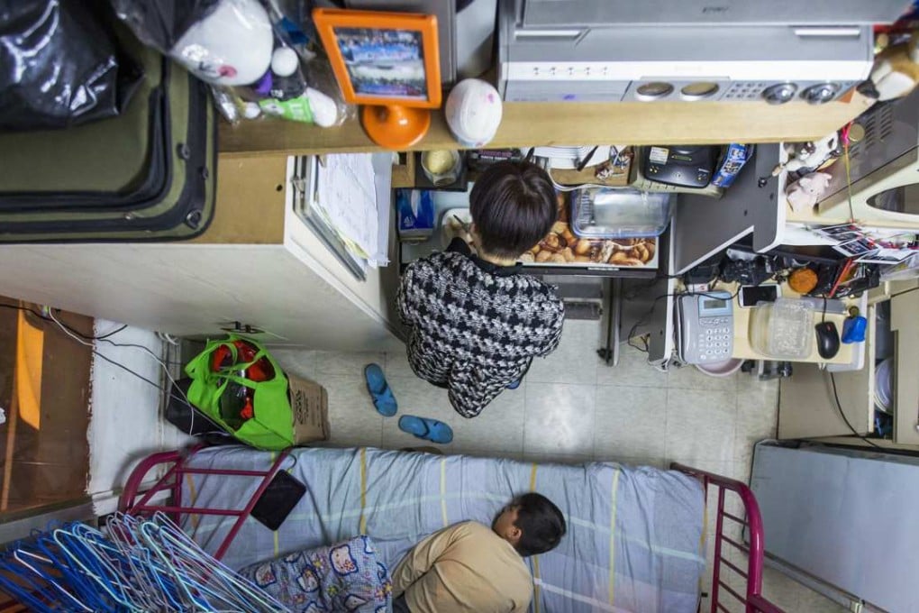 A woman and her son in their 60 sq ft subdivided flat in Hong Kong. Photo: Reuters