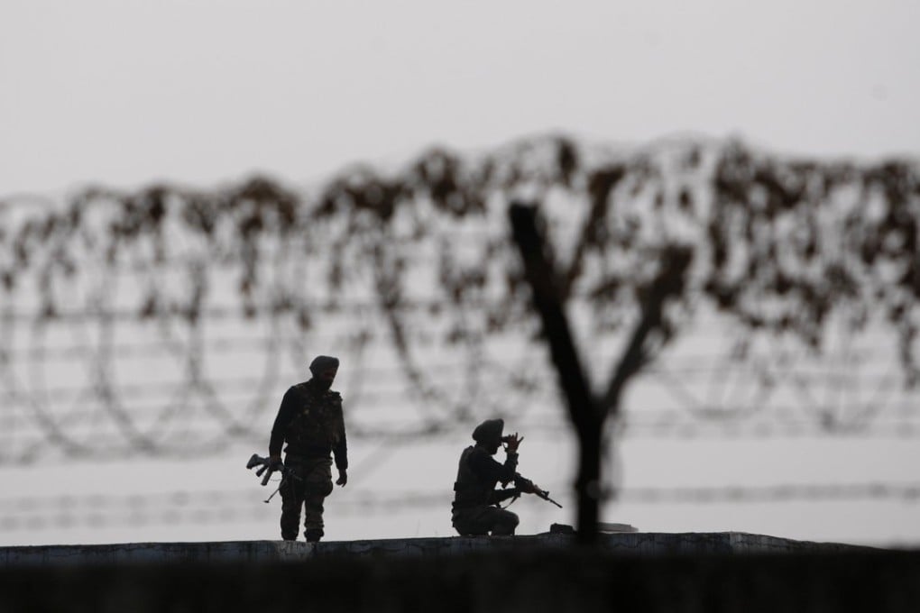 Indian soldiers keep guard at the perimeter fence of the Indian air force base in Pathankot, India, near the Pakistan border. Photo: AP