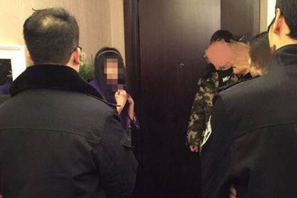 The woman, seen here outside the flat after being detained by police, could be mentally ill, says her father. Photo: The Beijing News
