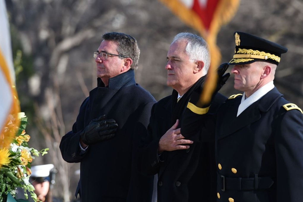 Australian Prime Minister Malcolm Turnbull(centre) takes part in a wreath laying with US Secretary of Defence Ashton Carter(left) and Major General Bradley A. Becker, at the Tomb of the Unknowns in Arlington National Cemetery on Monday. Photo: AFP