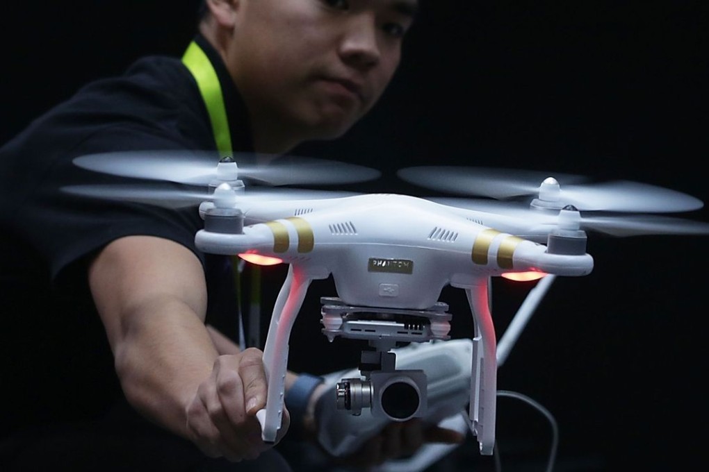 An employee of China’ s DJI, the global market leader for civilian drones, demonstrates one of the company’s ‘flying cameras’ at CES 2016 in Las Vegas on January 7. Photo: AFP