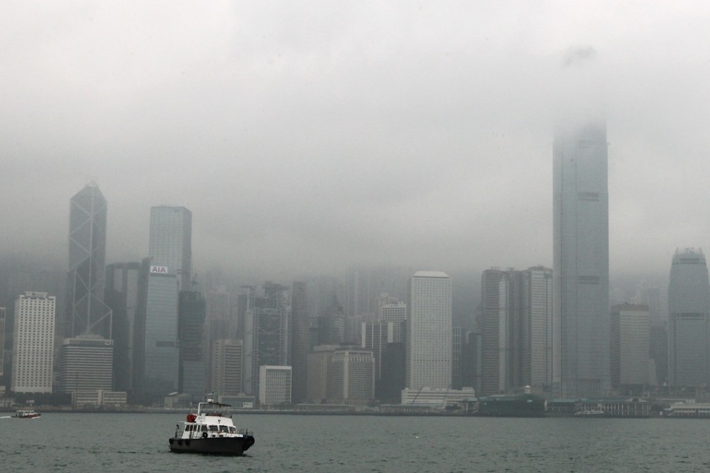 Thick cloud and fog shrouds the Victoria Harbour in Hong Kong.