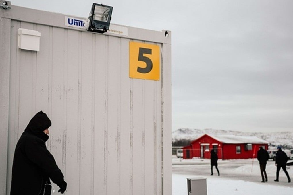 An asylum seeker smokes a cigarette at an arrivals centre for migrants in Kirkenes in northern Norway. Photo: AFP