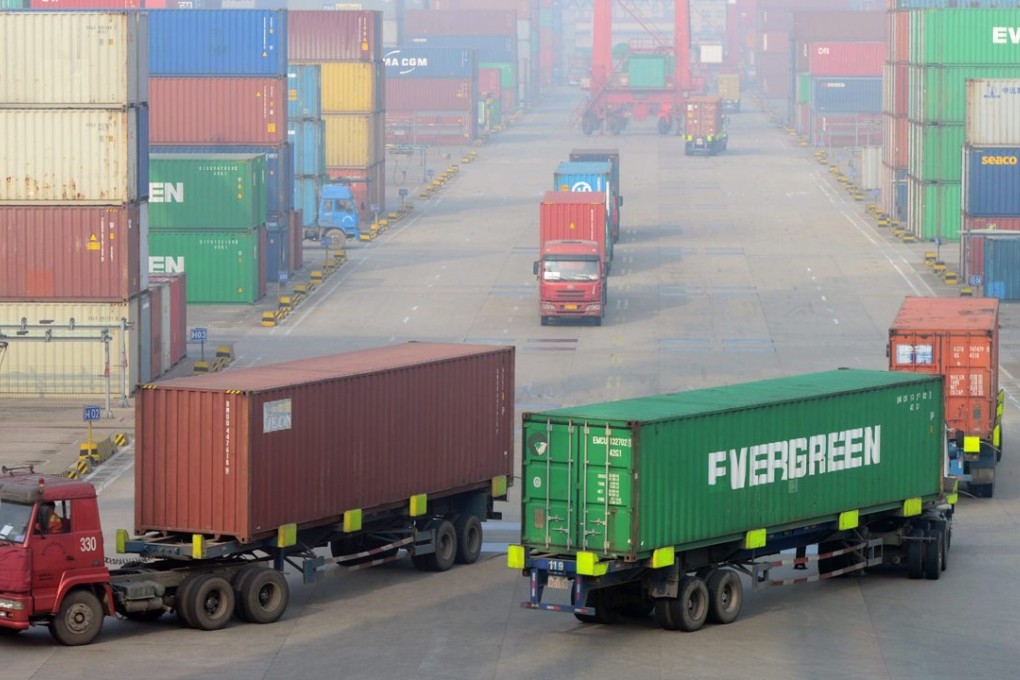 Trucks transport containers at a port in Qingdao, Shandong province. Photo: EPA
