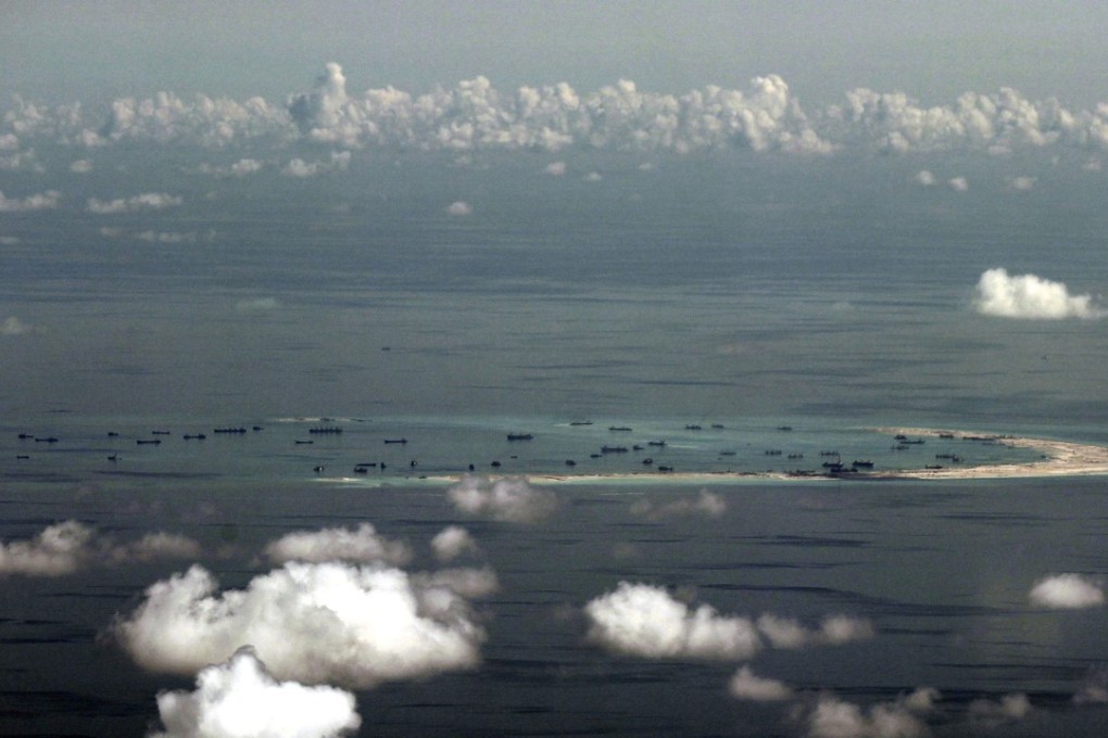 A photo taken from a military plane shows China's alleged ongoing reclamation at Mischief Reef in the Spratly Islands. Beijing’s campaign of island building in the South China Sea might soon quadruple the number of airstrips available to the PLA in the highly contested region. Photo: AP