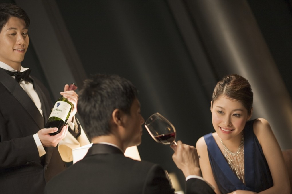 A Chinese couple enjoy a fine wine at a restaurant. Photos: Corbis