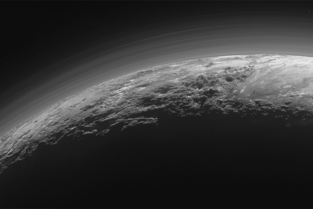 What lies beyond Pluto, seen here in a photo released in July 14 by Nasa? Photo: AP