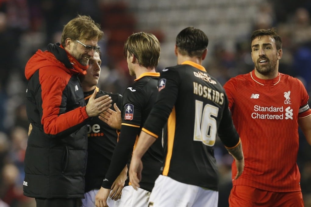 Liverpool manager Juergen Klopp congratulates Exeter players on an impressive performance in the FA Cup third round replay at Anfield. Photo: Reuters