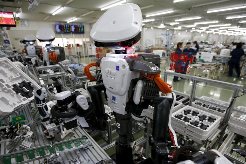 Humanoid robots work side by side with employees in the assembly line at a factory of Glory, a manufacturer of automatic change dispensers, in Kazo, north of Tokyo in this July 2015 file photo. But Japanese firms are not the only ones ramping up spending on robotics and automation. Photo: Reuters