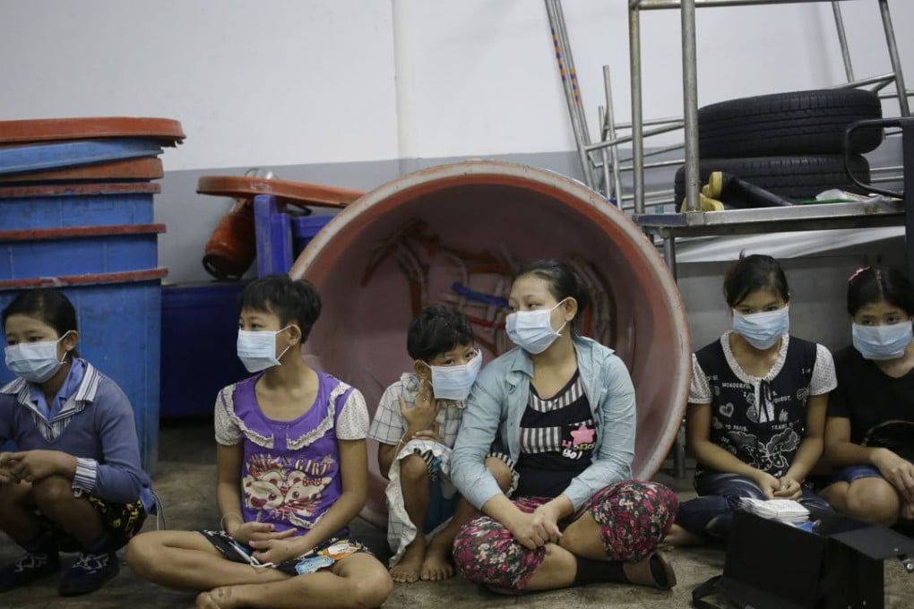 Children sit together to be registered by Thai officials during a raid on a shrimp shed in Samut Sakhon, which attracts workers from some of the world’s poorest countries, mostly Myanmar, many of whom are victims of forced labour. Photo: AP