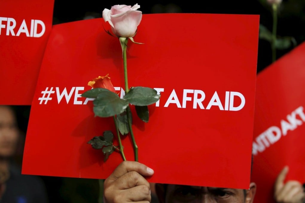People hold placards reading "We are not afraid" during a rally at the scene of the terror attack in central Jakarta. Photo: Reuters