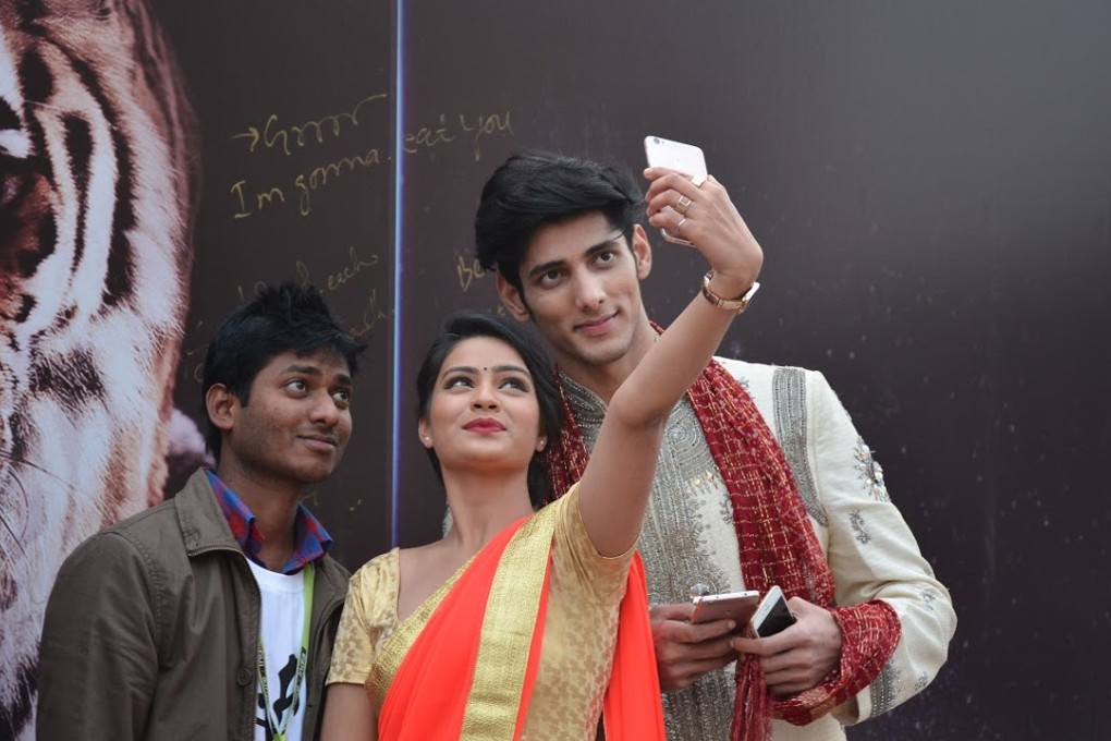 Models take selfies with one of LeEco’s smartphones in India earlier this week at the company’s launch event. Photo: Handout