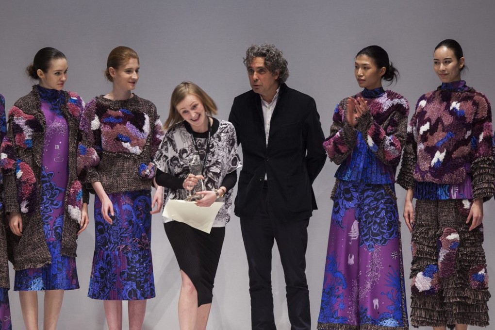 Polish designer Patrycja Guzik reacts to winning the grand prize in the Ecochic Design Awards 2016, as models wearing her winning collection look on. The awards are presented for sustainable fashion. Photo: EPA