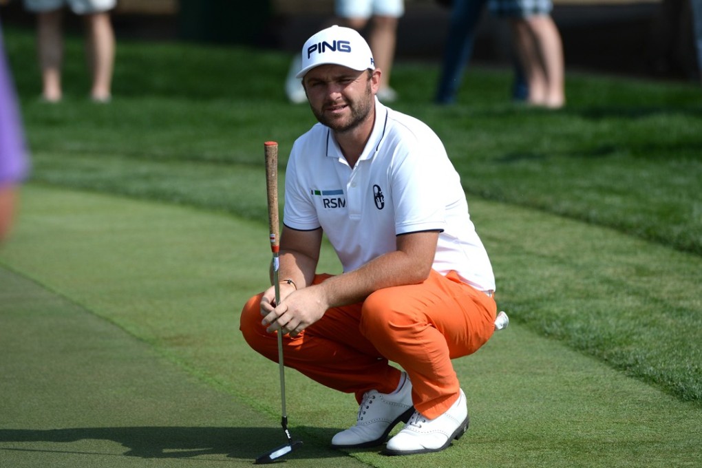 Andy Sullivan of England waits for his turn at the 14th green during the second round of the Abu Dhabi HSBC Golf Championship. Photo: AP