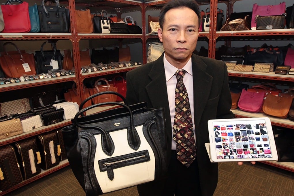 Superintendent Guy Fong displays some of the fake goods seized in the operation. Photo: Bruce Yan