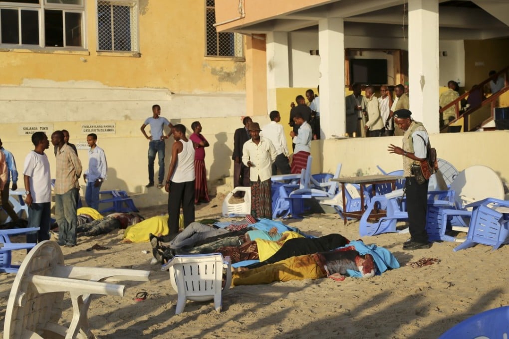 People search for friends and family among dead bodies on the beach in Mogadishu. Photo: AP