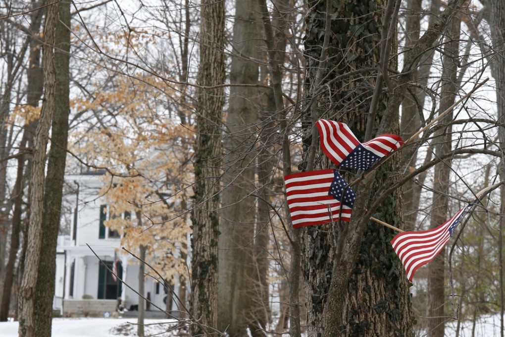 Small American flags have been placed in the trees in front of the Warmbier family home, in Wyoming, Ohio. Photo: AP