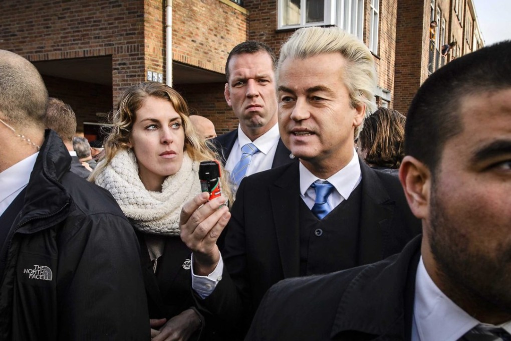 Party for Freedom leader Geert Wilders (centre) distributes fake pepper spray. Photo: EPA