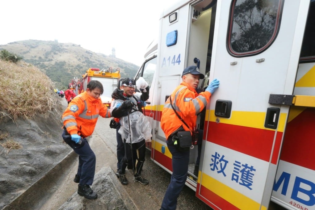 Emergency services assist those in danger of succumbing to hypothermia on Tai Mo Shan this morning. Photo: Felix Wong