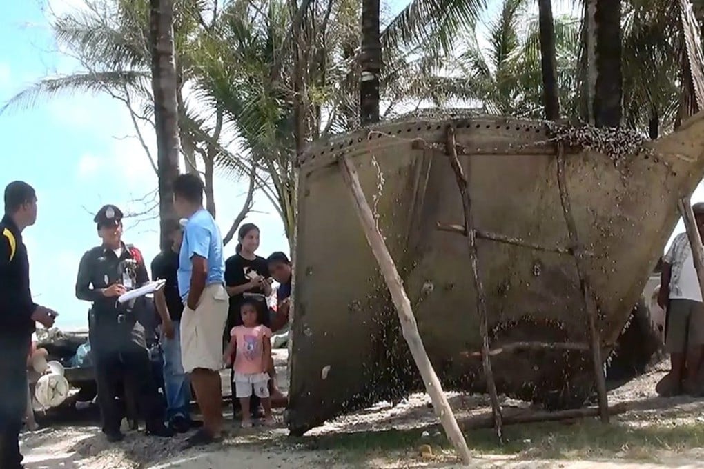 The large two metre by three metre curved piece of debris, was found by fishermen. Thai army aviation experts inspected the debris and took photographs. Photo: EPA