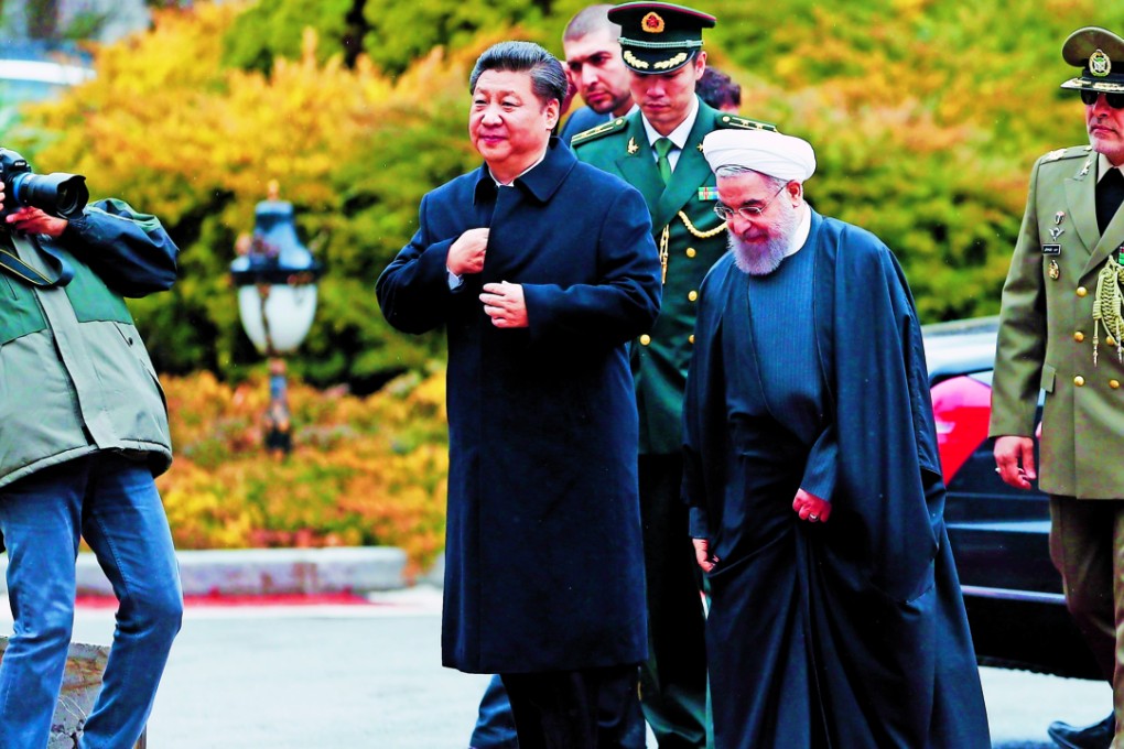 President Xi Jinping and his Iranian counterpart Hassan Rowhani arrive at the presidential palace in Tehran yesterday. Photo: EPA