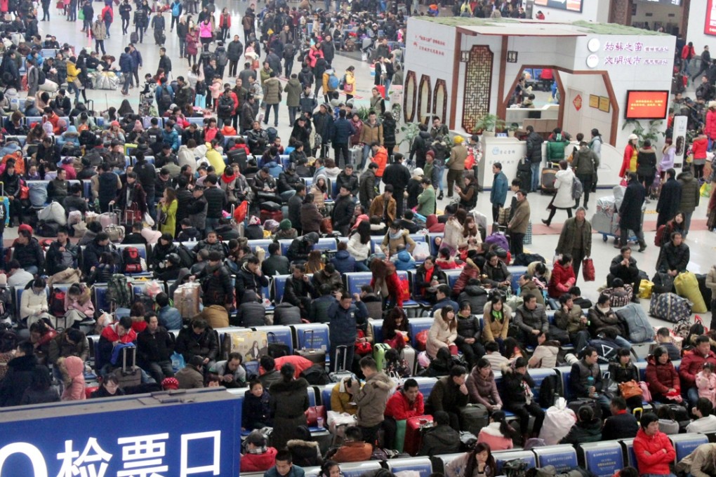 Passengers wait at a railway station in Suzhou, Jiangsu, at the start of the 40-day Lunar New Year travel season on Sunday. Photo: ChinaFotoPress