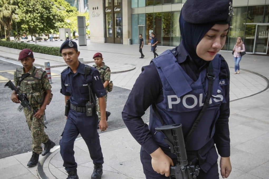 Malaysian military and police personnel patrol outside a Kuala Lumpur shopping mall. Photo: AP