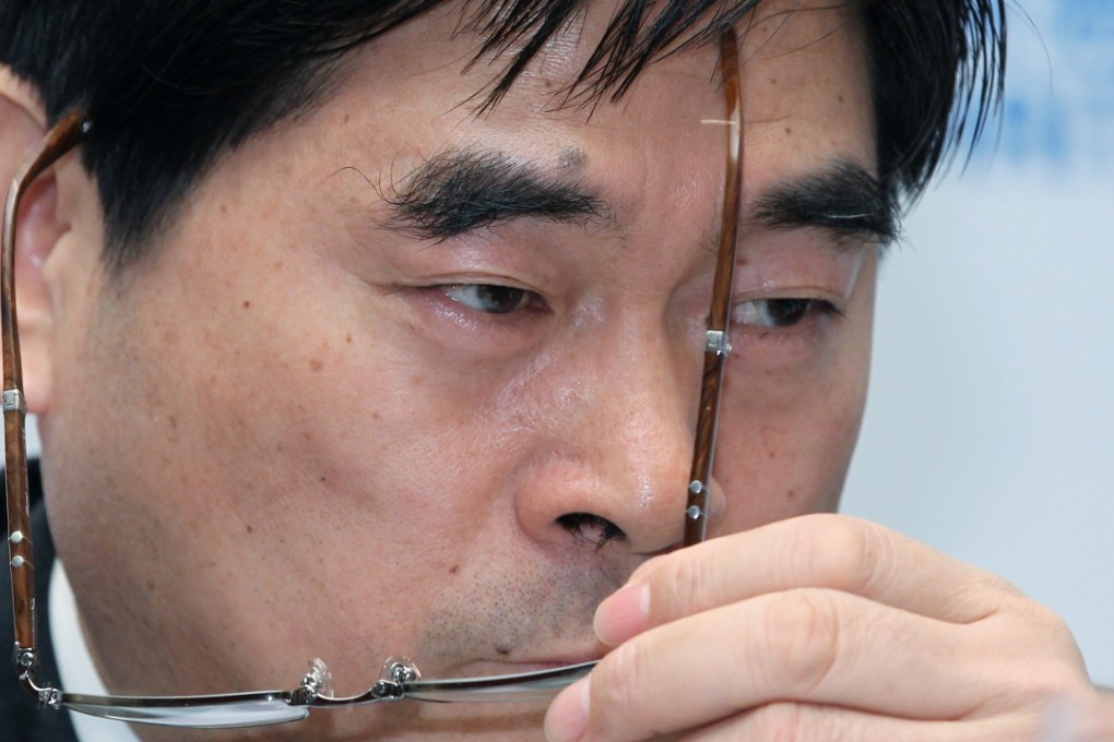 A file photo of Wang Zhenhua, Chairman of Future Land Development Holdings Limited, briefing the media on their global offering press conference in Hong Kong on November 18, 2012. Photo: Edward Wong, SCMP