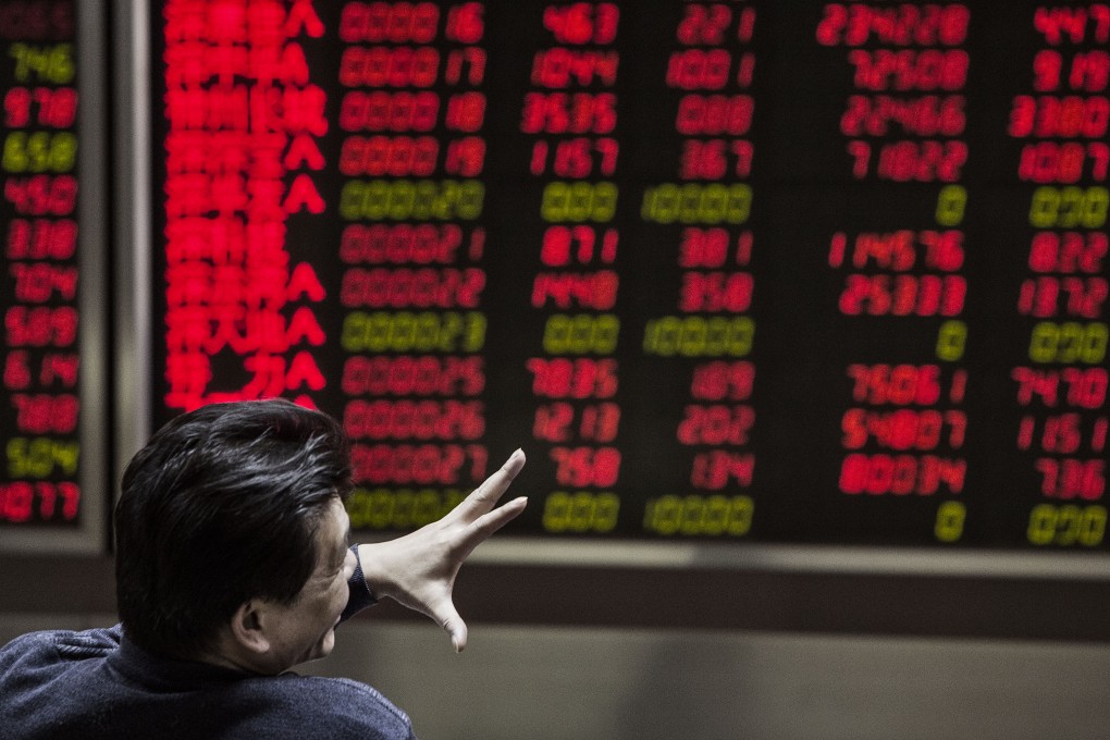 A man gestures in front of electronic boards displaying stock information at a securities brokerage in Beijing, China, on Monday, Jan. 18, 2016. China's economy slowed in December, capping the weakest quarter of growth since the 2009 global recession, as the Communist leadership struggles to manage a transition to consumer-led expansion. Photographer: Qilai Shen/Bloomberg ORG XMIT: 600596071