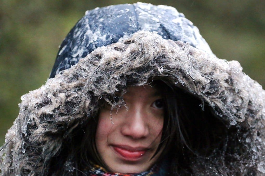 Visitors at Tai Mo Shan got covered with ice thanks to sub-zero temperatures there on Sunday. Photo: Felix Wong