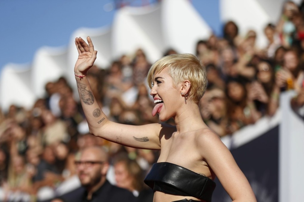 Miley Cyrus says she’s had a picture of Woody Allen by her bed for years. Photo: Reuters