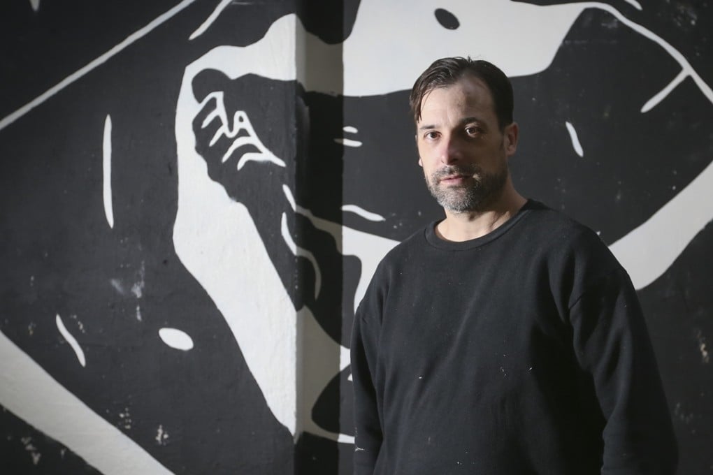 Street artist Cleon Peterson in front of his work in Sheung Wan. Photo: K.Y. Cheng