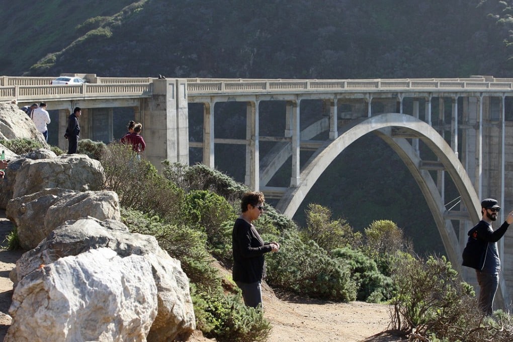 People watch searchers comb the area near Bixby Creek Bridge in California, looking for two people feared dead after a base jumping accident in Big Sur. Photo: AP