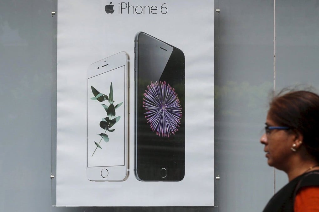 A pedestrian walks past an Apple iPhone 6 advertisement at an electronics store in Mumbai, India. The company reported meagre iPhone growth and forecast this week its first revenue drop in 13 years, making the Indian market a rare bright spot for Apple. Photo: Reuters