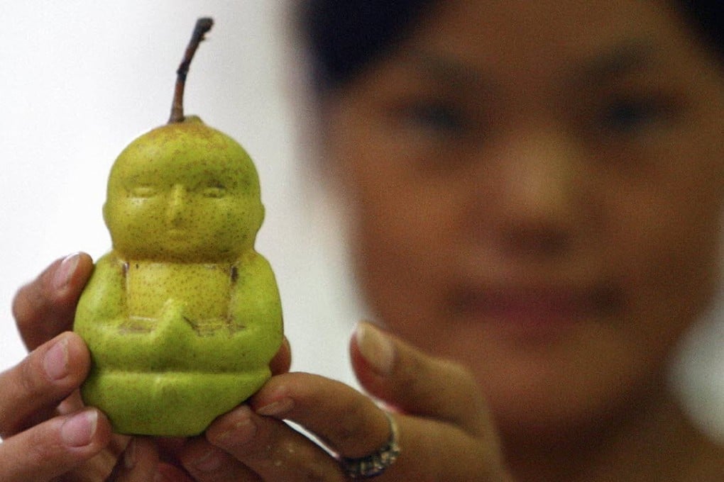 A Buddha shaped pear is displayed at an orchard in Weixian county, Hebei province. Photo: Reuters
