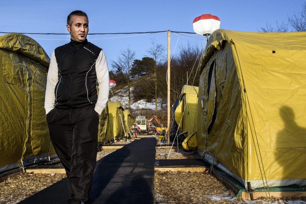 Mohamad Salai, a refugee, walks through a tent camp in Naestved, some 60km south of Copenhagen. Photo: EPA