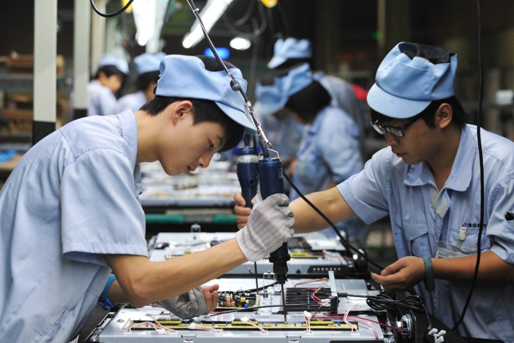Chinese workers work on a television set assembly line in a factory in northeastern China’s Liaoning province. Photo: EPA