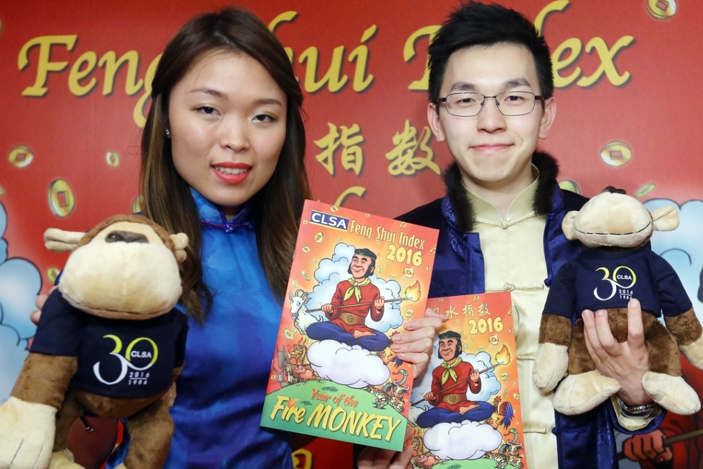 CLSA technology analyst Cherry Ma and bank analyst Marco Yau unveil the firm’s feng shui index at the China Club. Photo: Edmond So