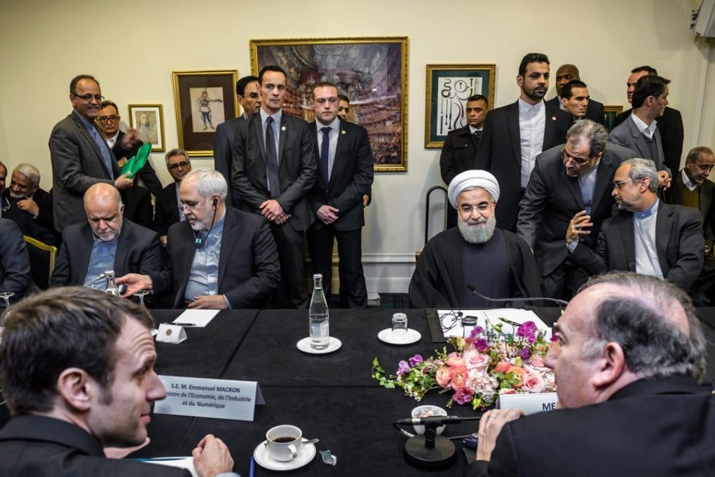 Iranian President Hassan Rouhani (back, center right) and Iranian Foreign Minister Javad Zarif (back, centre left) attend a meeting with French Economy Minister Emmanuel Macron (front left) and the head of French business federation Medef, Pierre Gattaz (front right) in Paris on Wednesday. Photo: EPA