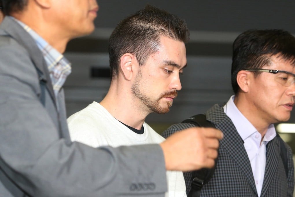 Arthur Patterson, an American charged with murdering a Seoul university student in 1997, is escorted by South Korean police officers upon his arrival at Incheon International airport in Incheon. Photo: AP