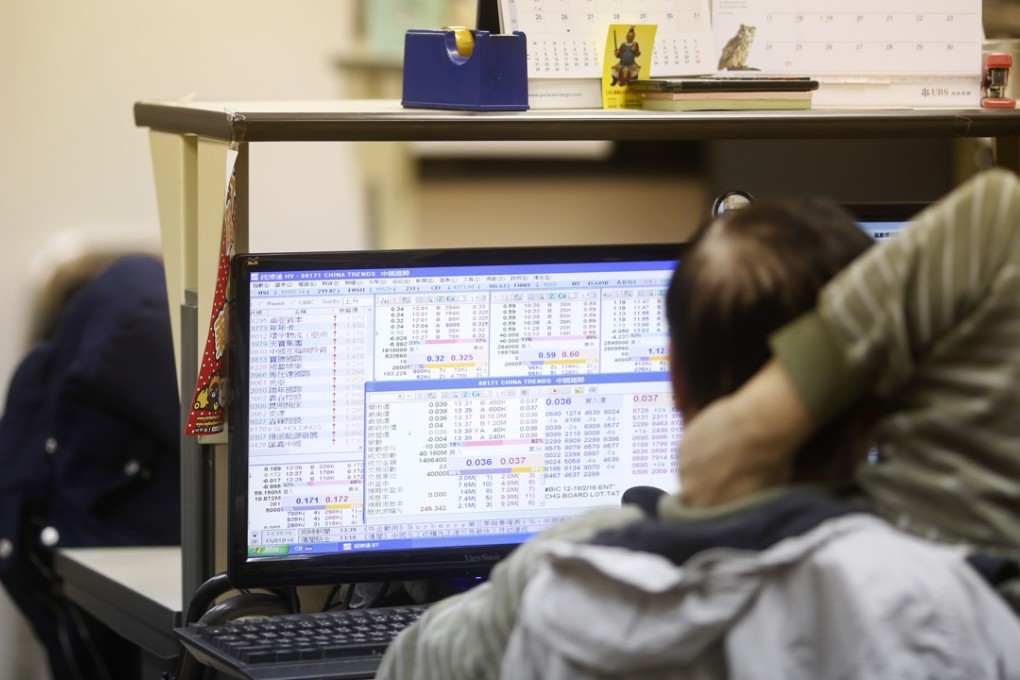 A stockbroker looks at stock information on a computer screen at a securities brokerage in Hong Kong. Photo: Bloomberg