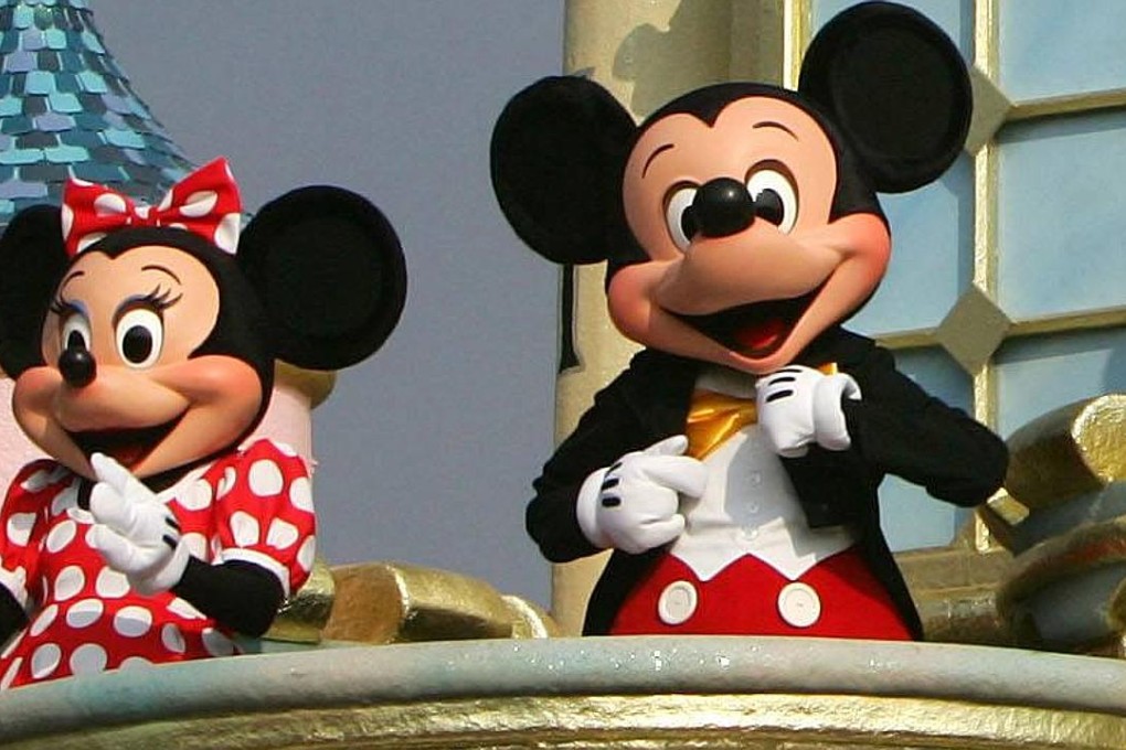 Mickey Mouse (R) and Minnie Mouse perform during "Disney On Parade" show at Hong Kong Disneyland September 12, 2005, a day before the grand opening of the theme park. Disney officially opens its new Hong Kong theme park on Monday, bringing a slice of the Magic Kingdom to the Middle Kingdom with a careful blend of American showmanship and Chinese characteristics. REUTERS/Paul Yeung