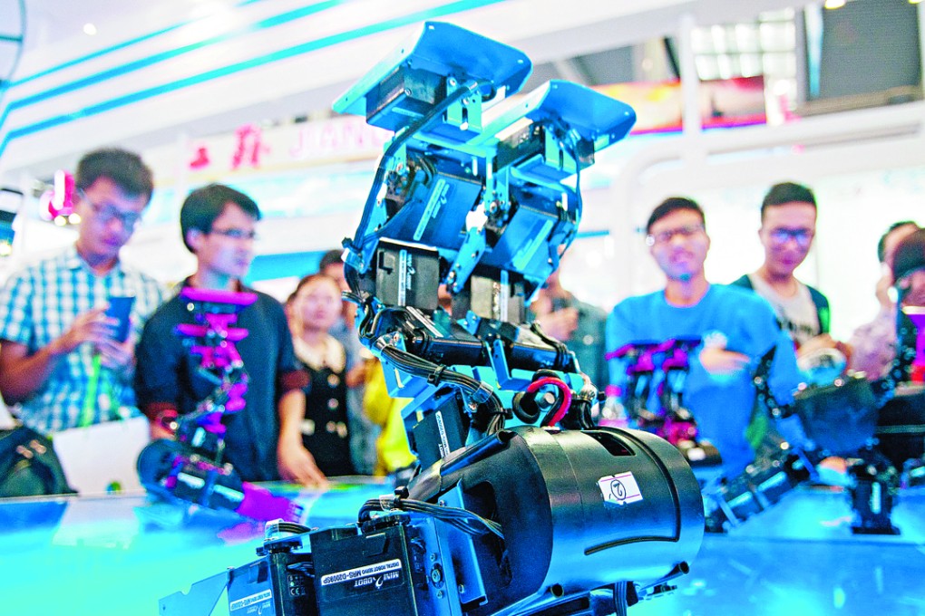 Visitors view a demonstration of dancing robots at a hi-tech fair in Shenzhen. The city’s growth last year was 8.9 per cent, well above the 6.9 per cent growth China saw as a whole. Photo: Imagine China