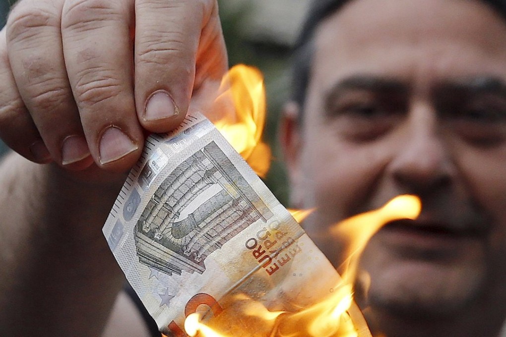 An anti-austerity protester burns a euro note during a demonstration outside the European Union offices in Athens. Once voters make the connection between anti-austerity and anti-EU, euro-sceptic sentiment, the single currency will be in trouble. Photo: Reuters