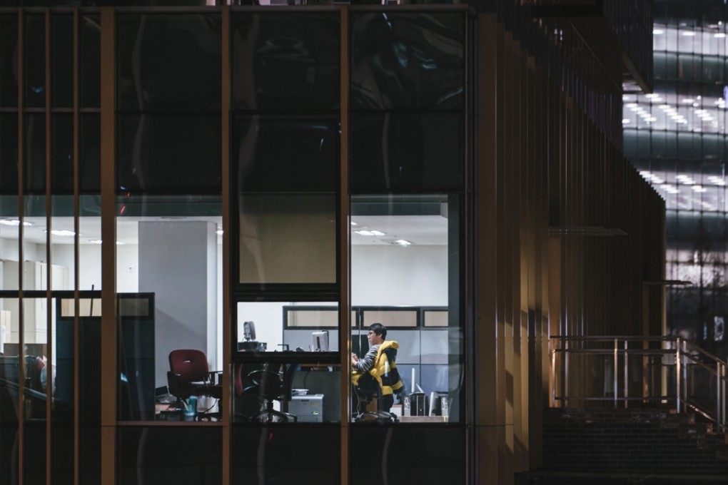 A lone office worker is doing an overtime shift in downtown Seoul; young people in South Korea complain that life there is "hell." Photo: Jun Michael Park for The Washington Post