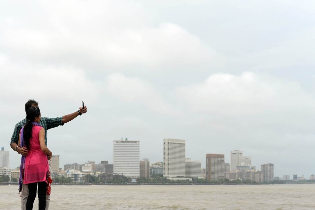 A couple take a selfie on Marine Drive promenade, one of 16 dangerous spots in Mumbai. Photo: AFP